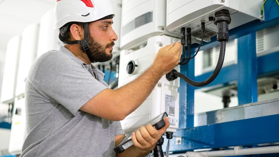 A man checks the integrity of the connector cables
